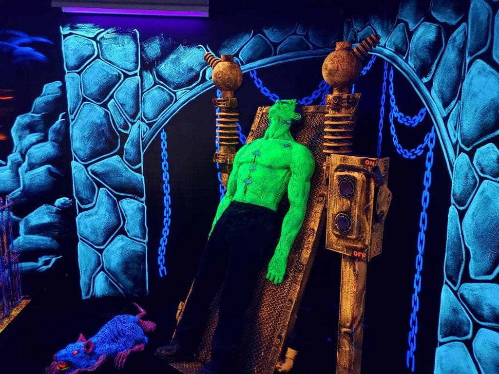 A neon monster decoration at a monster mini golf location.
