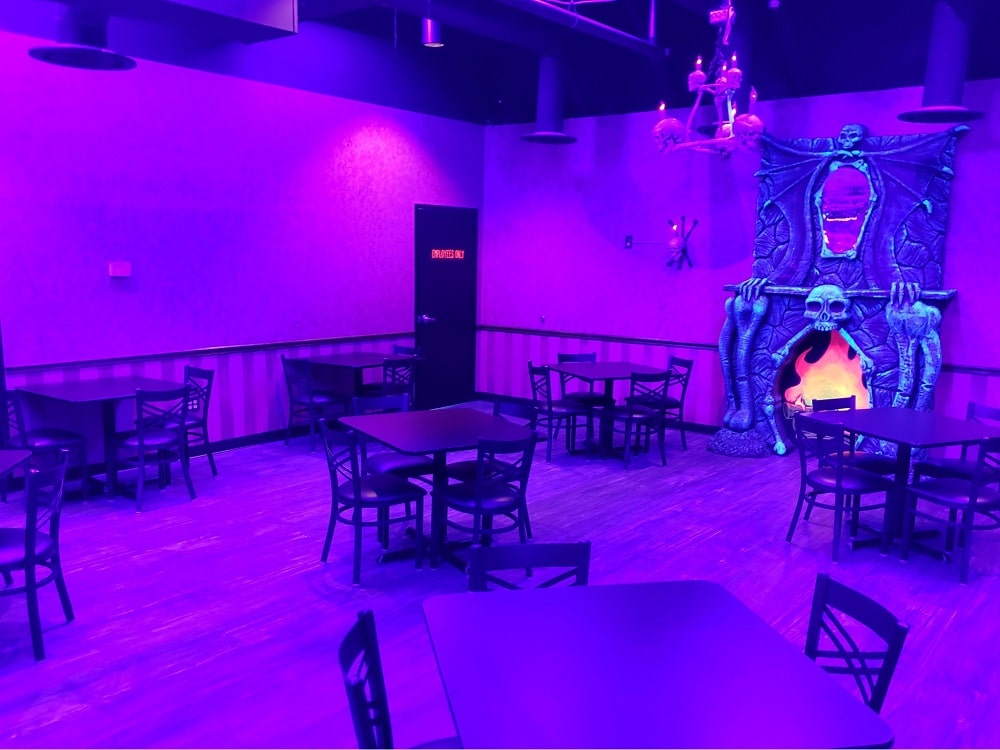 Stella'S Kitchen 2 Seating options under purple neon lights at stella's kitchen at monster mini golf.